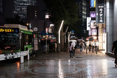 People on illuminated city at night