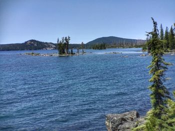 Scenic view of lake against clear blue sky