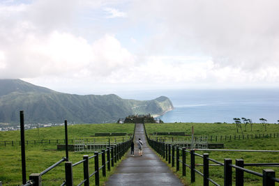 Scenic view of sea and mountains against sky