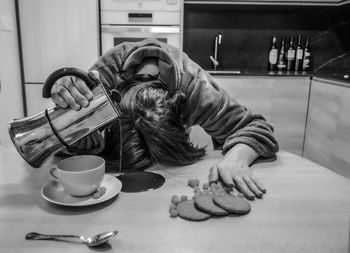 Midsection of man with coffee at home