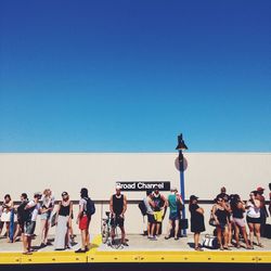 People against clear blue sky