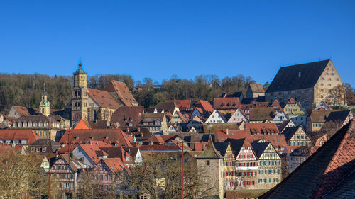 High angle view of townscape against clear blue sky