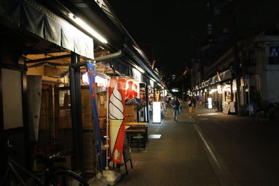 People in illuminated city at night