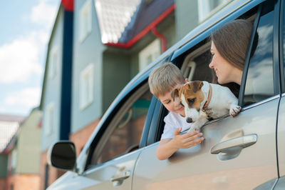 Woman with dog on car window