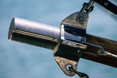 Close-up of metallic railing against sky