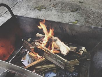 High angle view of fire on barbecue grill