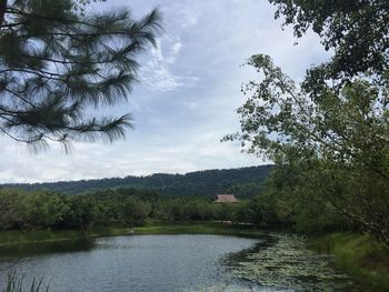 Scenic view of river and mountains against sky