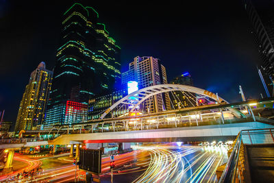 Illuminated modern buildings against sky at night