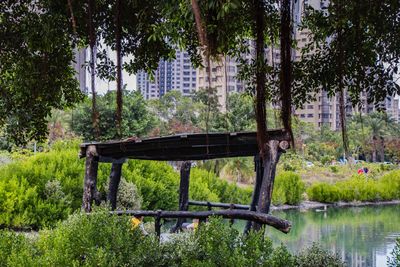 Bridge over lake against trees in park