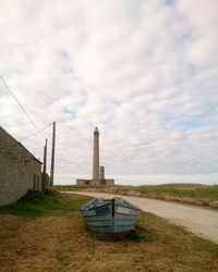 Lifeguard hut on field against sky