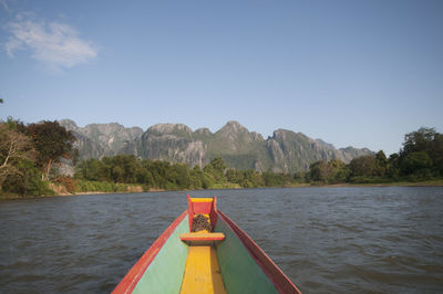 Scenic view of river and mountains against clear sky