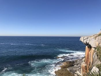 Scenic view of sea against clear blue sky