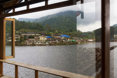 Scenic view of river seen through window