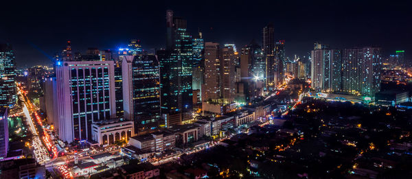 Aerial view of city lit up at night