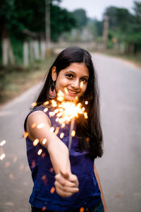 Portrait of a smiling young woman standing outdoors