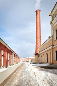 Street amidst buildings against sky