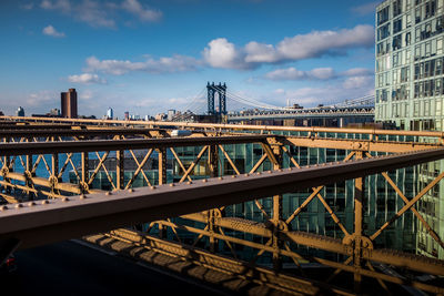 Manhattan bridge in city against sky