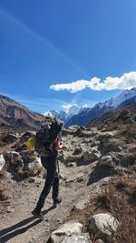 Women standing on mountain against sky