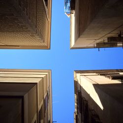 Low angle view of buildings against blue sky