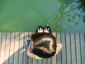 High angle view of boy holding toy at swimming pool