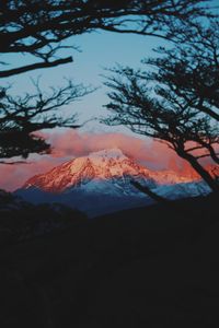 Scenic view of snowcapped mountains against sky during sunset