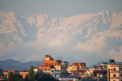 Buildings in city against sky