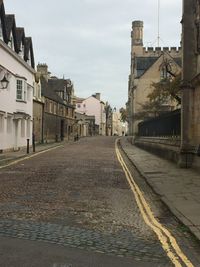 Street amidst buildings against sky in city