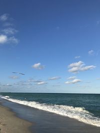 Scenic view of sea against blue sky