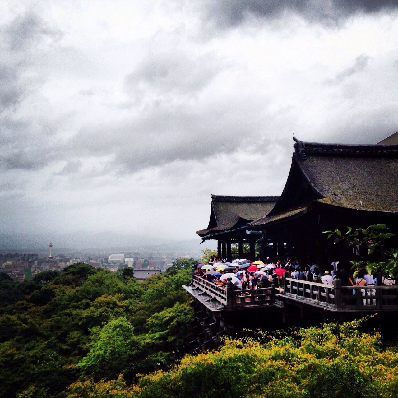 sky, built structure, architecture, large group of people, building exterior, person, cloud - sky, lifestyles, tree, leisure activity, men, cloudy, roof, cloud, mixed age range, tourist, outdoors, day, travel destinations