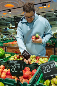 Side view of man preparing food at market