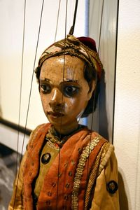 Close-up of marionette by wall
