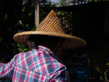 Rear view of man with hat on rock