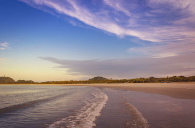 Scenic view of beach against sky during sunset