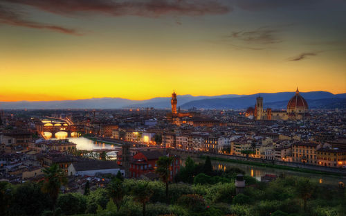 High angle view of buildings in city at sunset