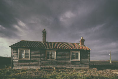 House against cloudy sky