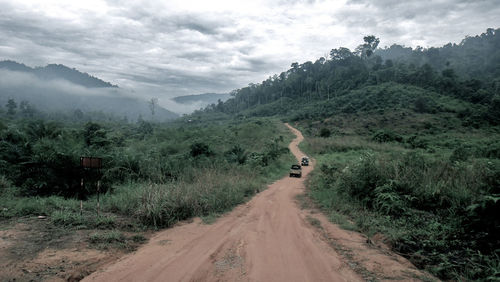 Road amidst mountains against sky