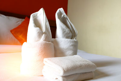 Close-up of towels on bed in hotel