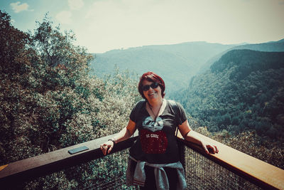 Portrait of young woman standing on mountain