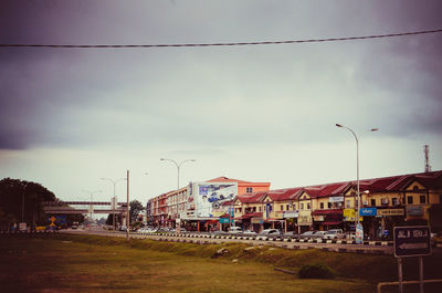 Road by city against sky