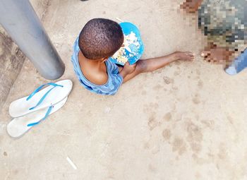 High angle view of boy sitting on beach