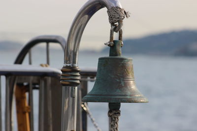 Close-up of bell in sea against sky