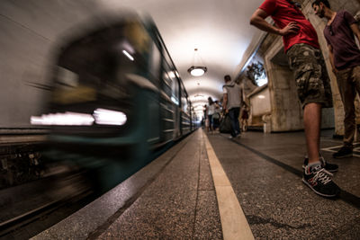 Low section of woman at railroad station