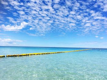 Scenic view of sea against blue sky