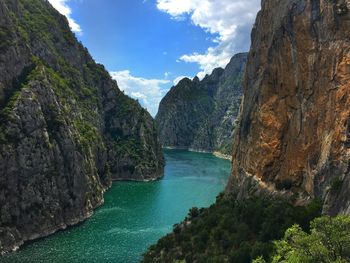 Scenic view of sea and mountains against sky