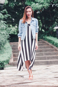 Portrait of smiling young woman standing outdoors