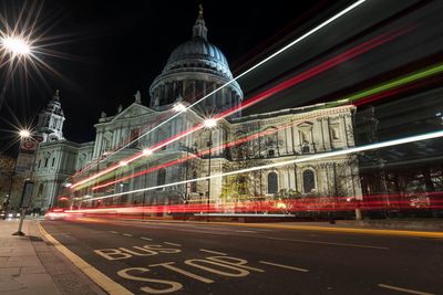 Light trails on road against st paul cathedral