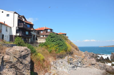 View of sea and buildings against sky