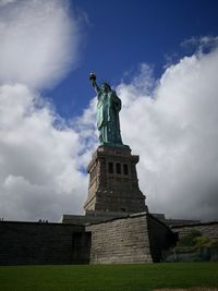 Low angle view of statue against cloudy sky