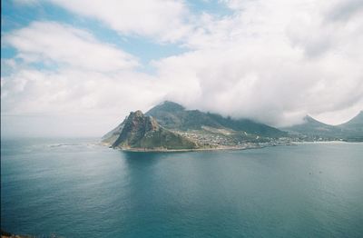 Scenic view of sea and mountains against sky