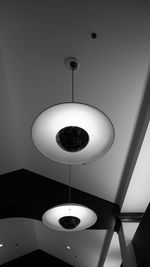 Low angle view of illuminated pendant light hanging from ceiling